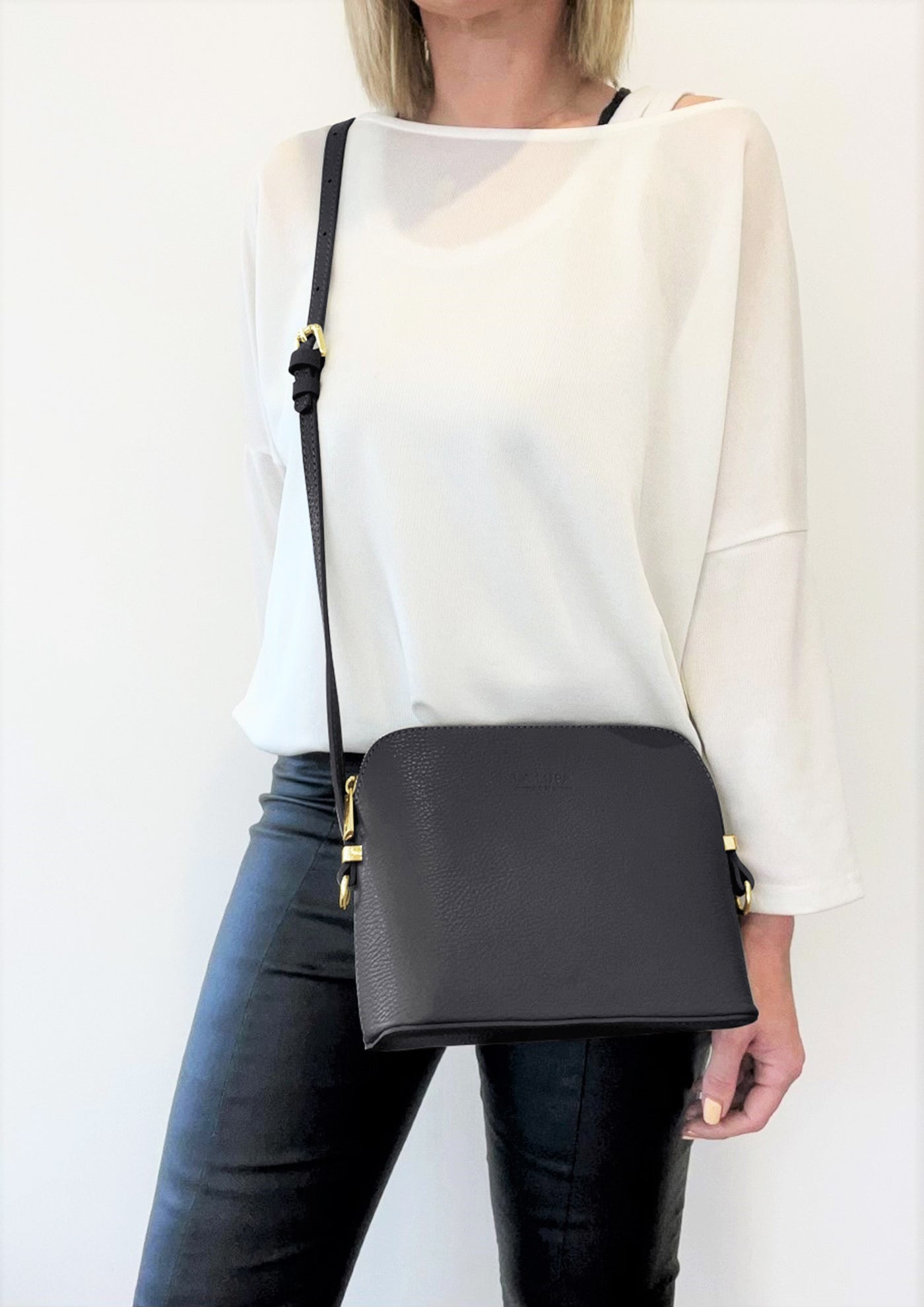 Claudia Black Crossbody Italian Leather handbag by LA LUPA  / model wears bag across body