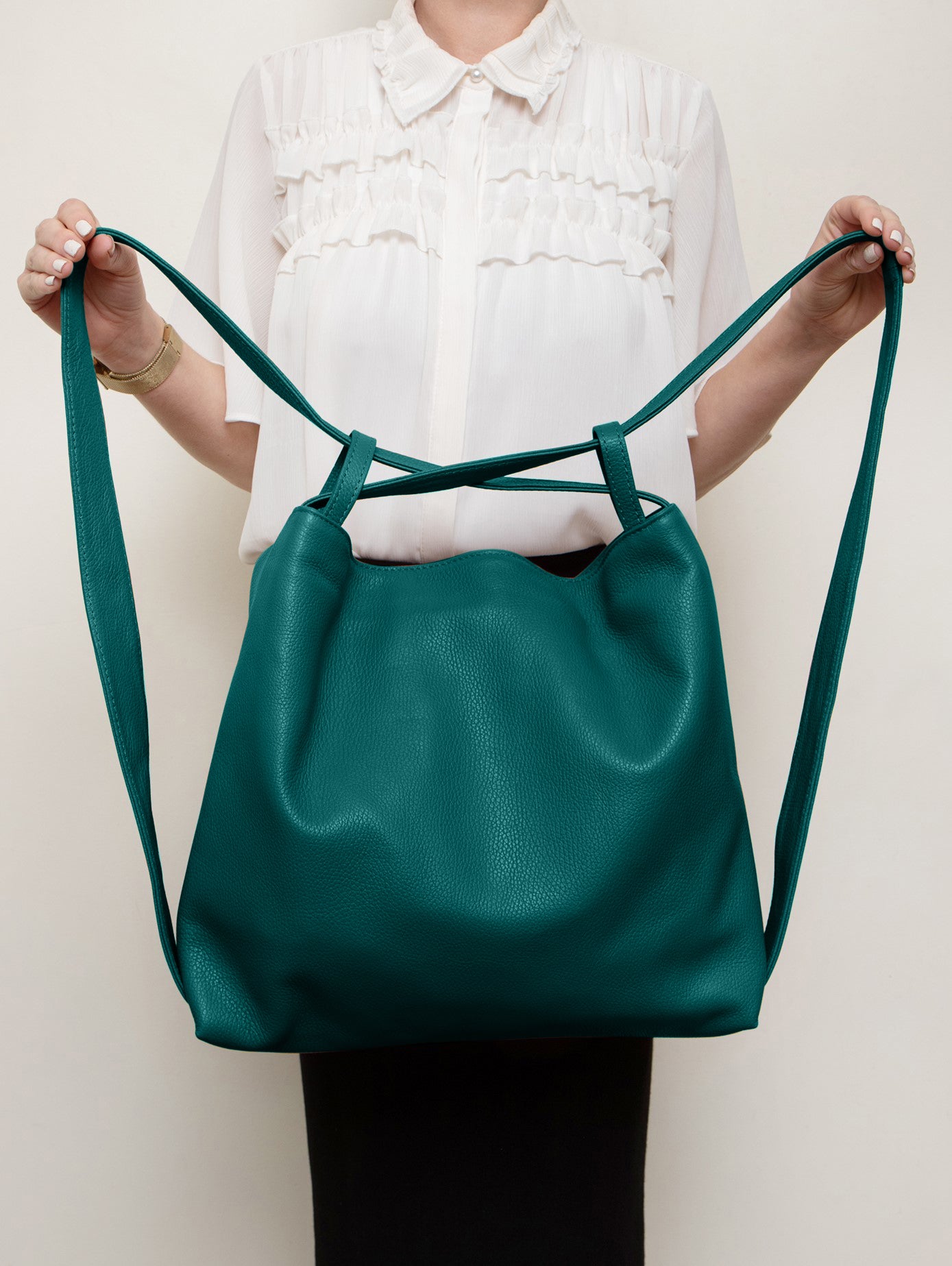 Bella 2-in-1 Teal Italian Leather Backpack and Tote by LA LUPA / Model shows how the tote can be converted into a backpack